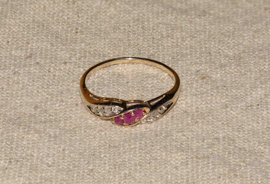 Ruby and diamond yellow gold twist ring